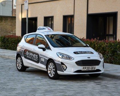 Sign written driving school car with branded graphics and magnetic roof sign box for learner driver visibility